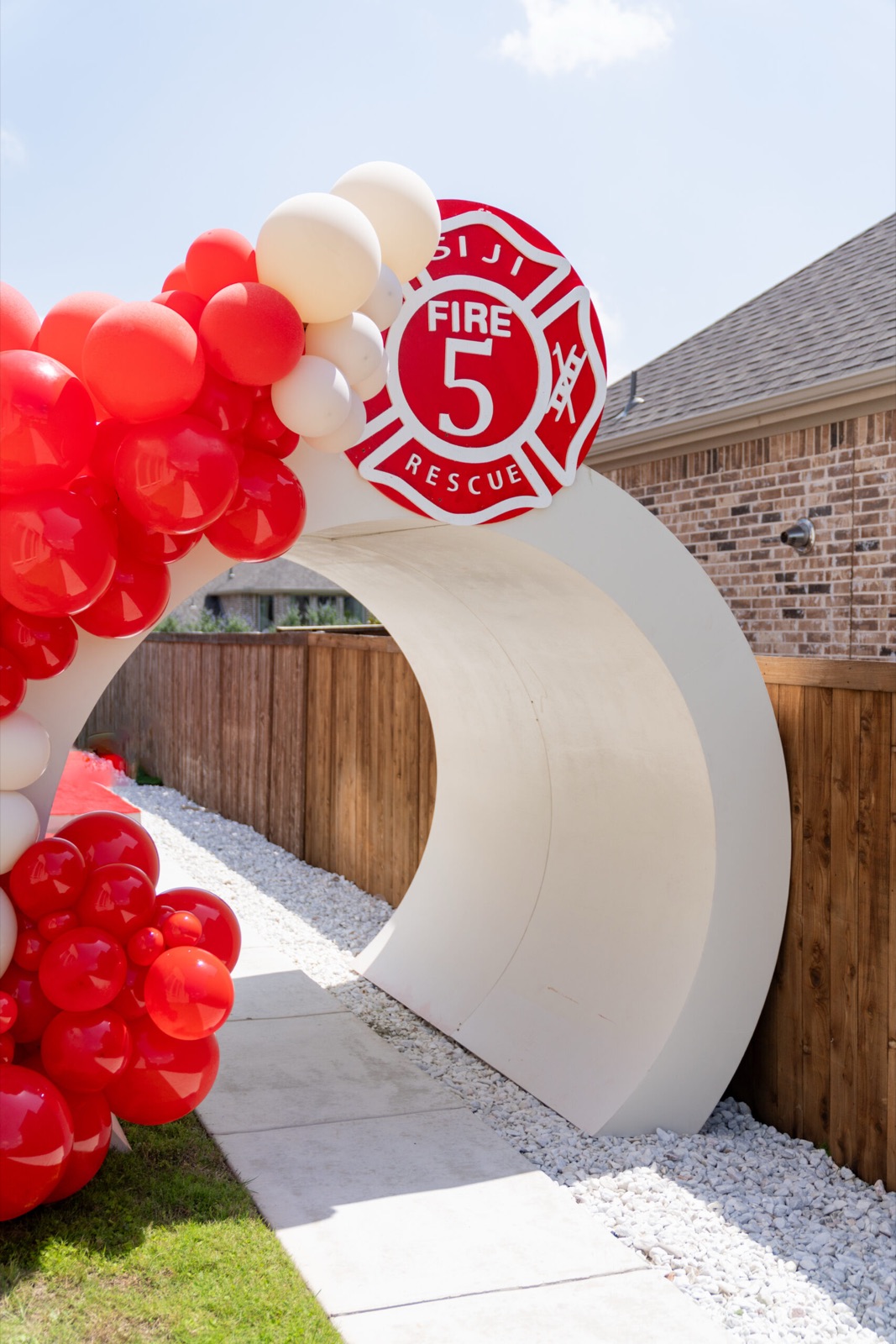 Custom fire-department arch with red balloons