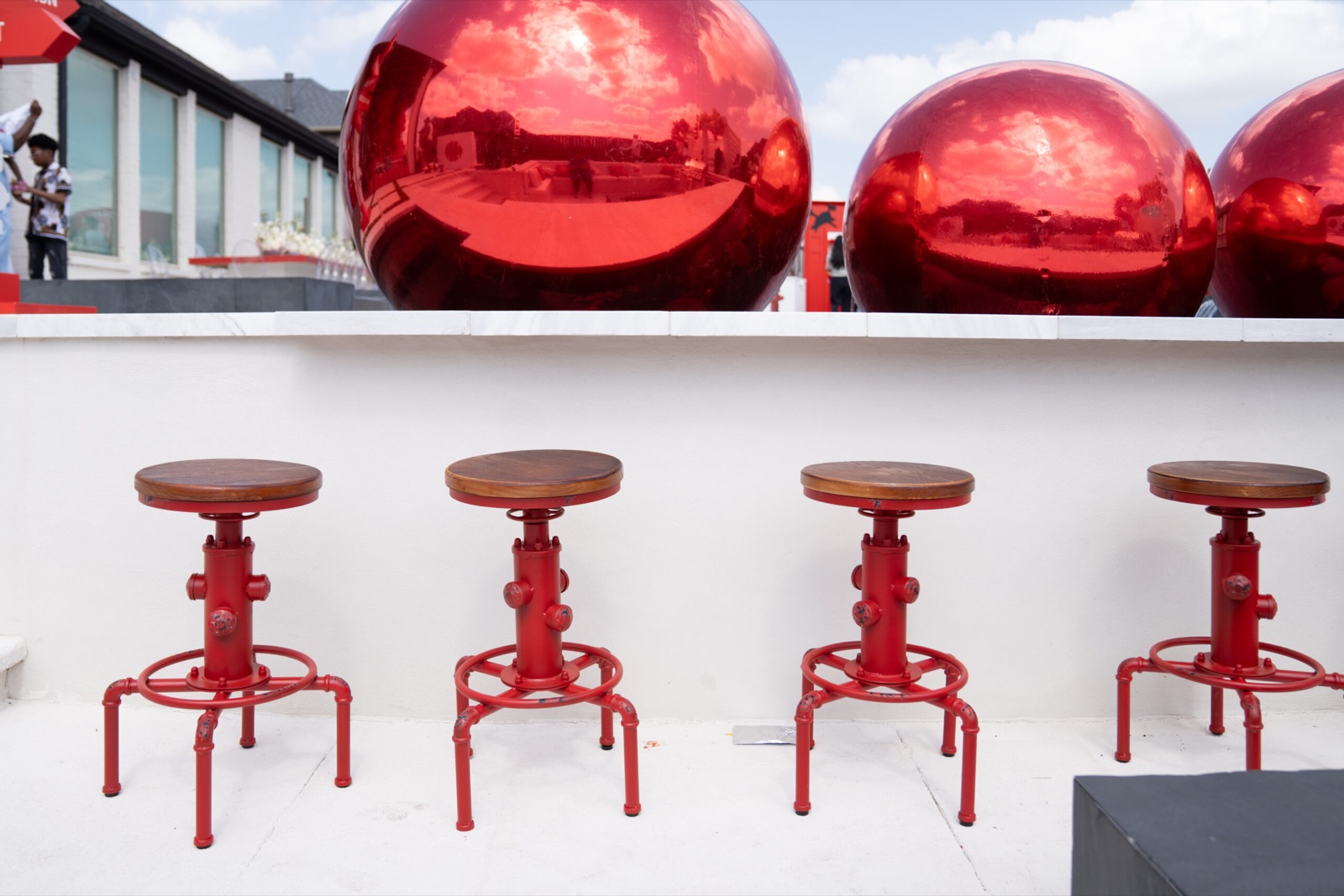 Red counter stools by a white lounge