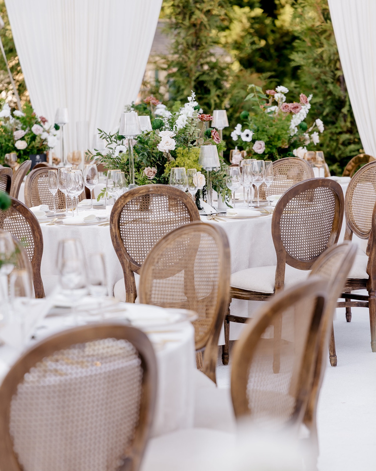 Reception tables set beneath a clear-top tent
