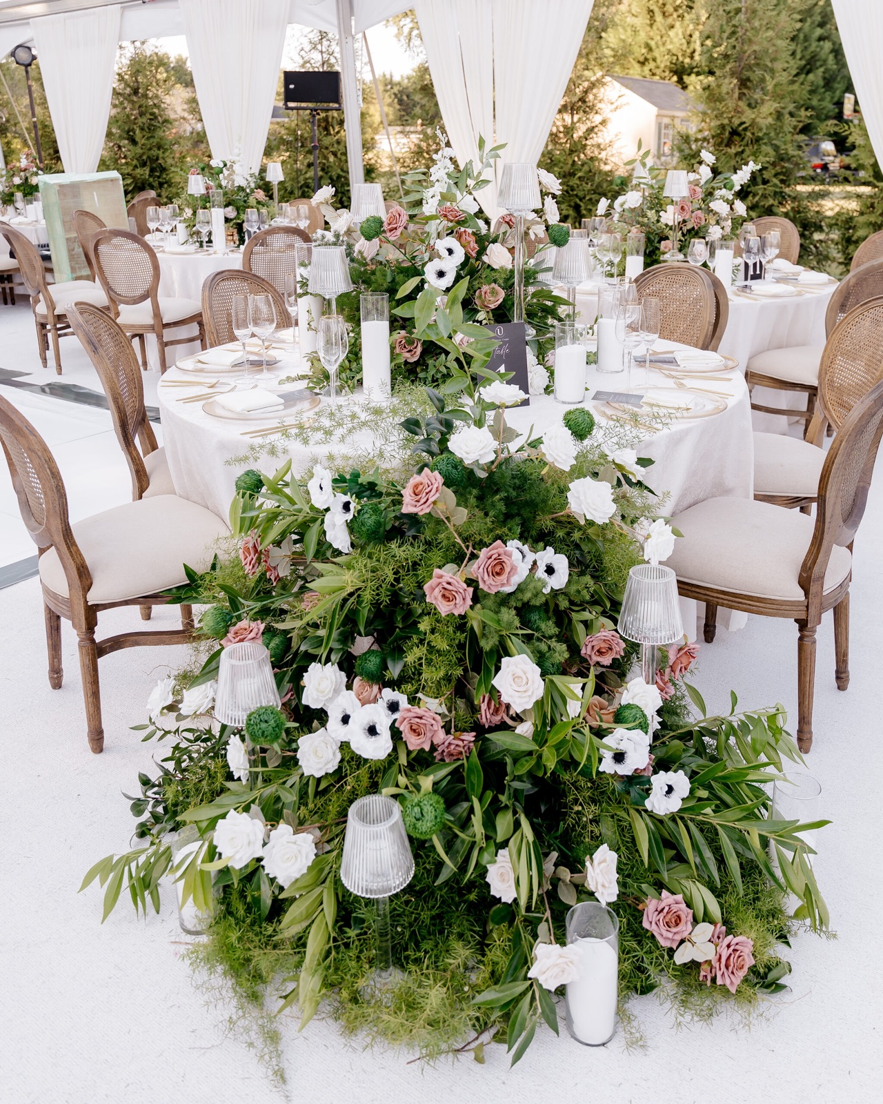 Lush floral installation cascading over a dining table