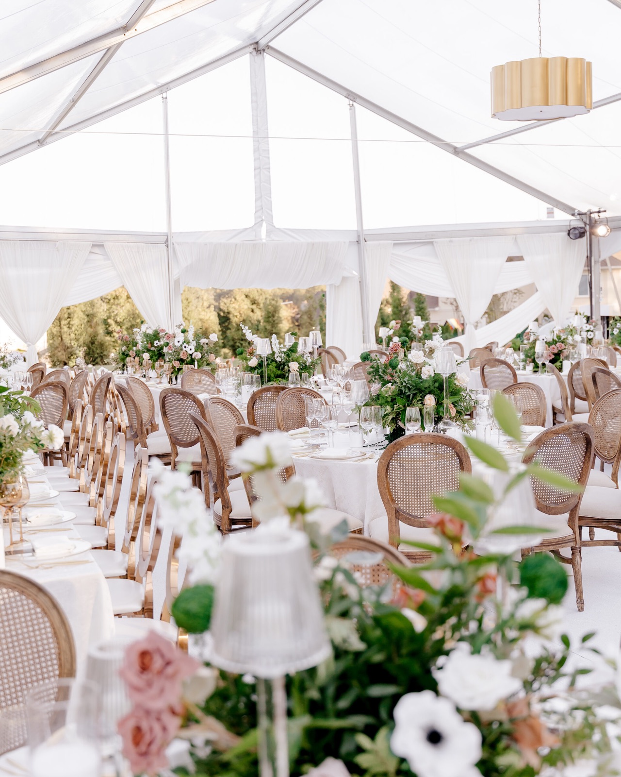 Reception tent with garden florals and soft candlelight