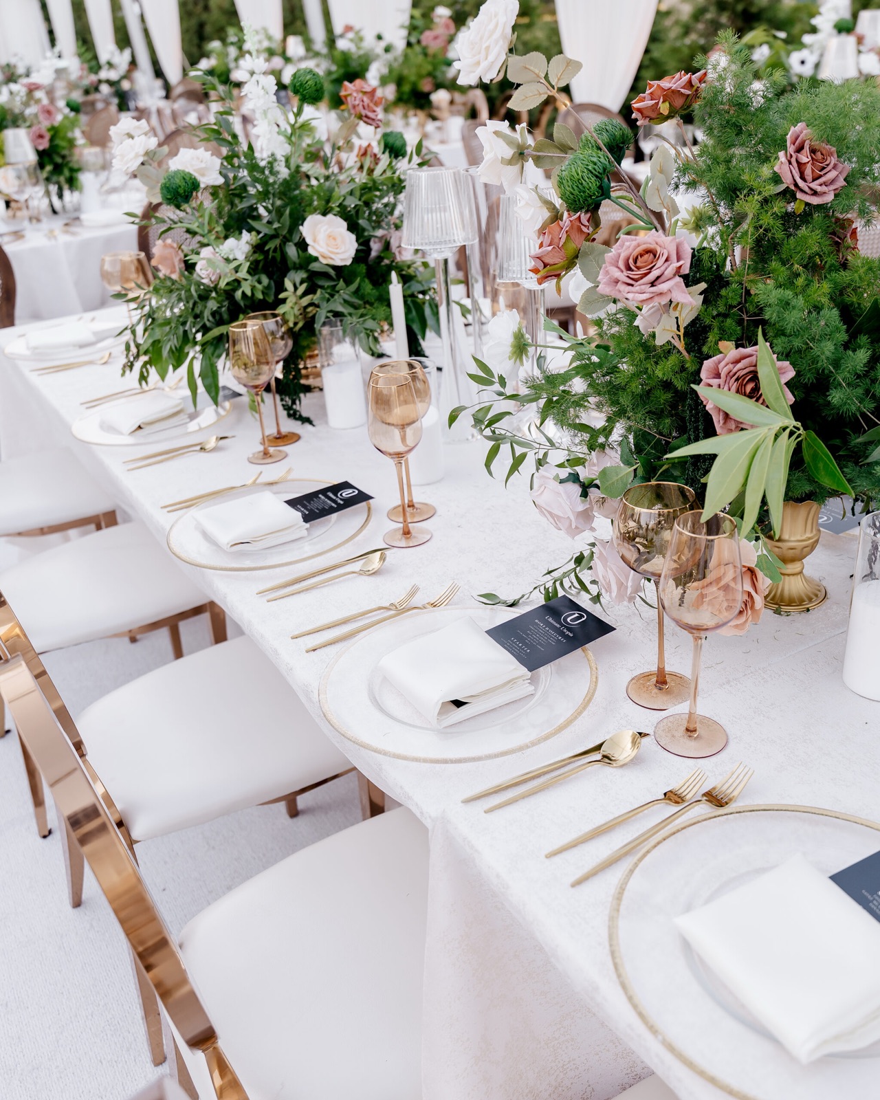 Long dining table with cascading floral centerpieces
