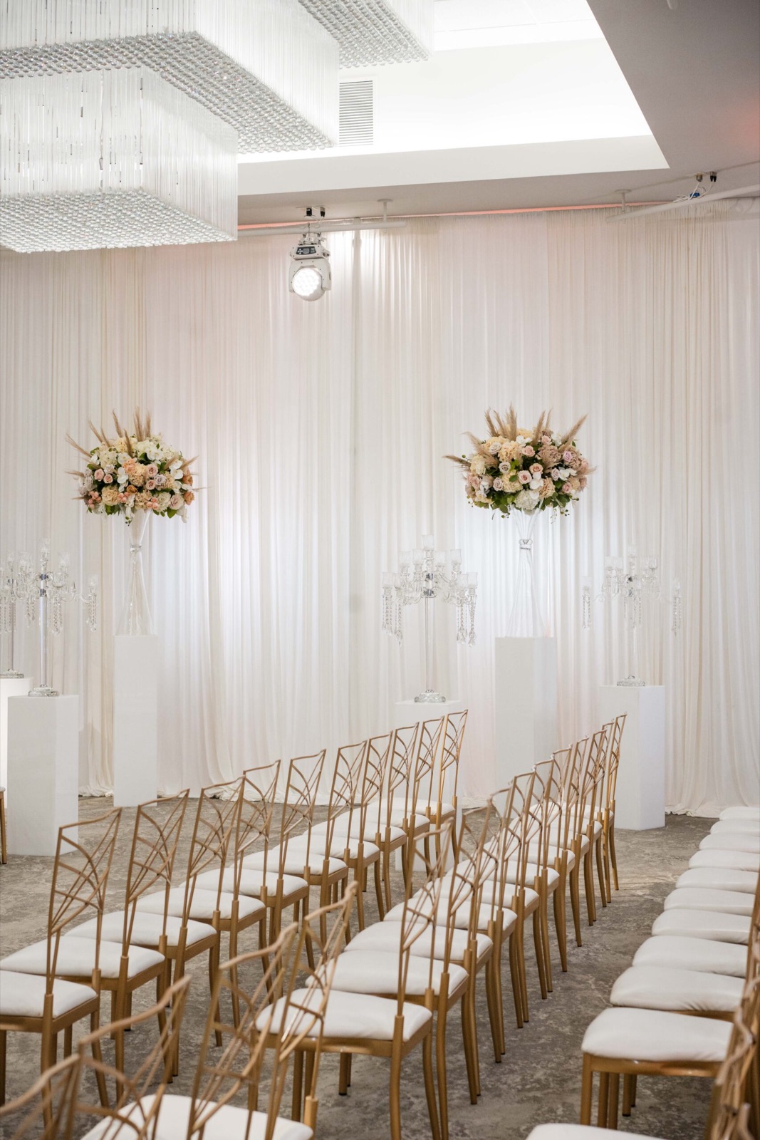 White ceremony aisle lined with floral columns