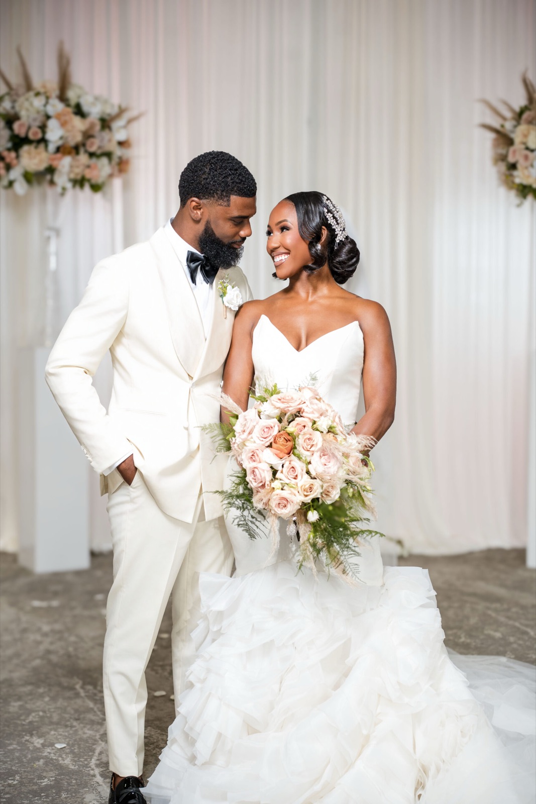 Couple before a floral backdrop