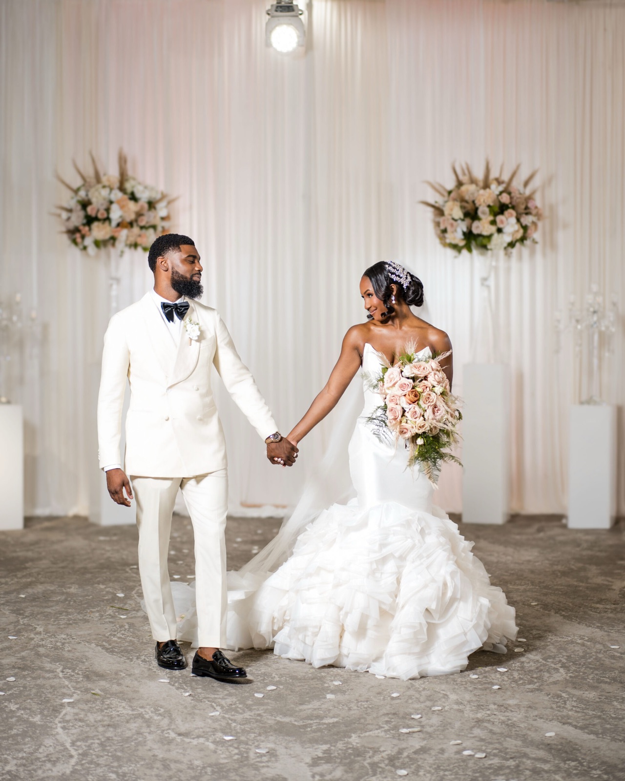 Couple before a floral backdrop